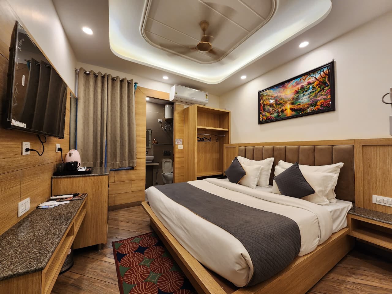 Deluxe room with king bed, wood panelling and smart TV