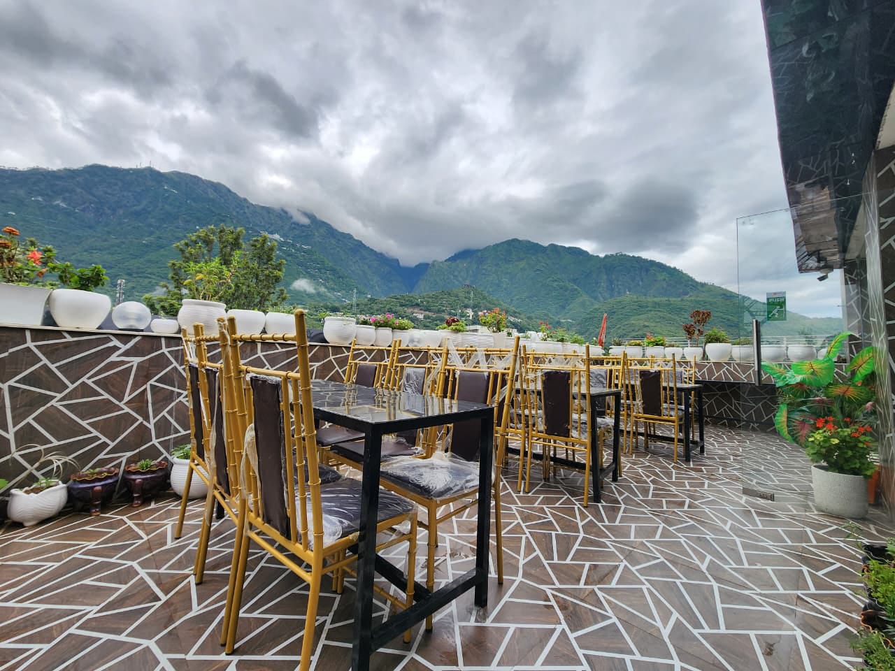 Rooftop dining terrace facing the Trikuta hills